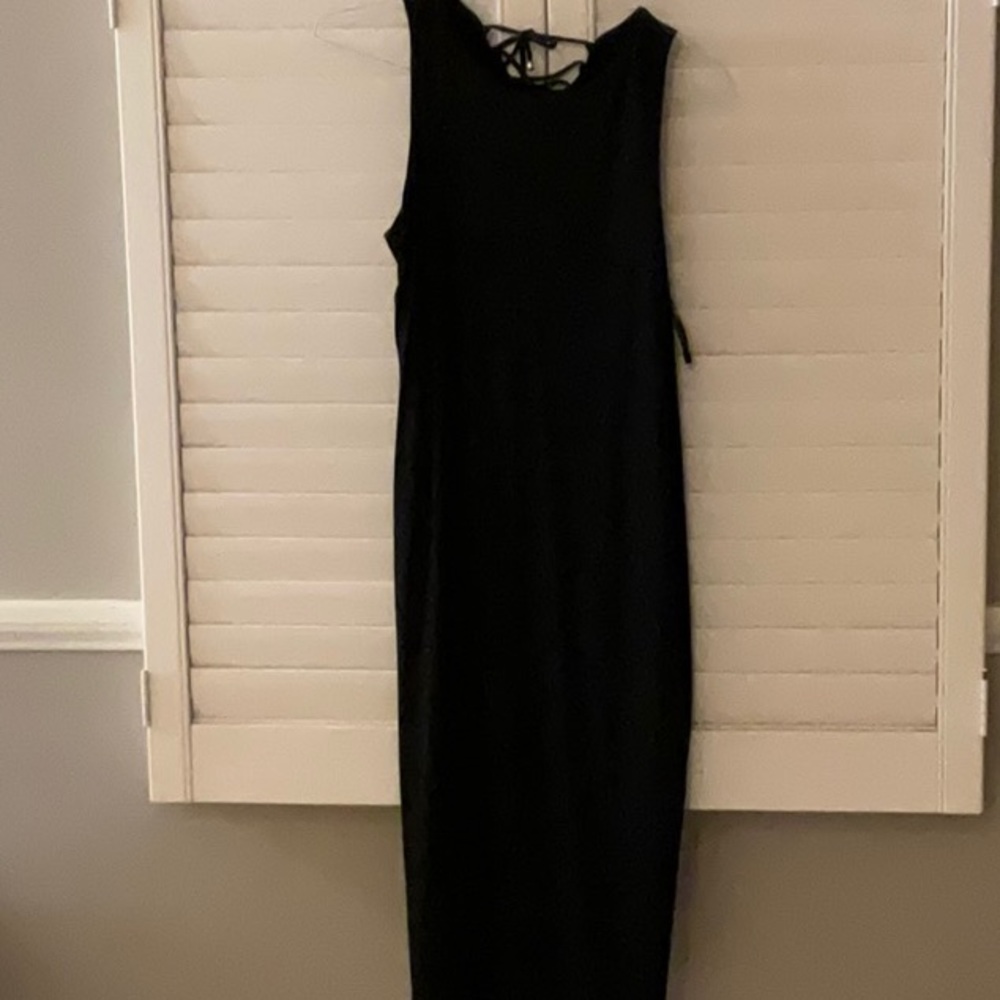 Formfitting black stretch dress with lace up back